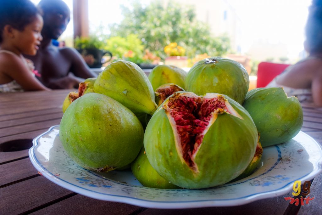 A PLATE OF GREEN FIGS - SYKA AND ONE HAS BURST OPEN