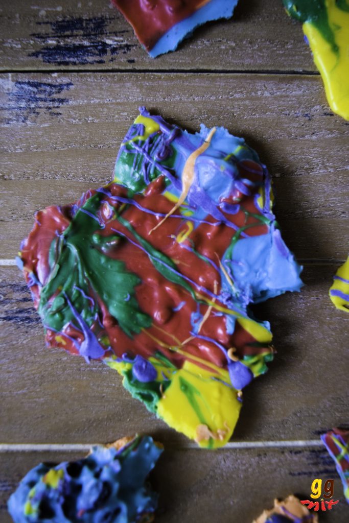  a broken piece of rainbow chocolate coloured in an abstract way with red, orange, yellow, green, blue and purple