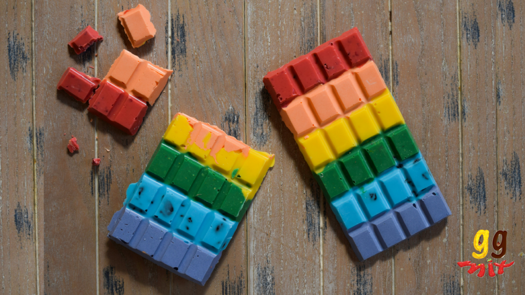 two rectangular rainbow chocolate bars coloured red, orange, yellow, green, blue and purple